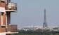 A woman enjoys the sun on her balcony as the Eiffel Tower is clearly seen in the background during the nationwide confinement to counter the conoravirus in Saint-Cloud, west of Paris, Wednesday, April 22, 2020. Air pollution has fallen in Paris in response to the lockdown measure to fight the spread of the COVID-19.